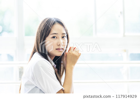 High school girl sitting on a chair in the classroom High school girl sitting on a chair in the classroom 117914929