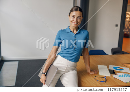 A Professional Woman Embodies Poise and Efficiency in a Modern Office Setting and Environment 117915257