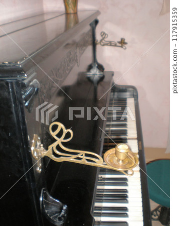 ancient piano with candlesticks in the museum ancient piano with candlesticks in the museum 117915359