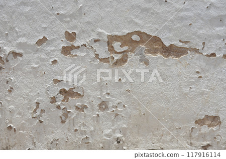 Texture or background of the building's walls are painted white, old and damaged. 117916114