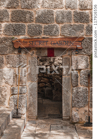 Krk Croatia 26.06.24 Entrance to the secret garden of the cafe near the pier Krk Croatia 26.06.24 Entrance to the secret garden of the cafe near the pier 117916556
