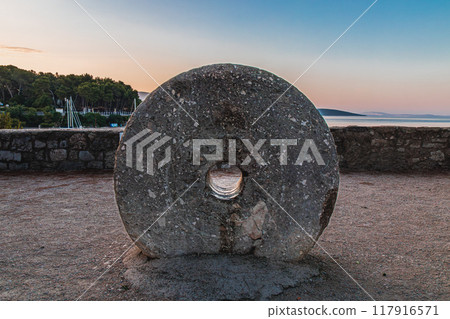 Krk Croatia A round port stone in a small square near the sea and the fortress Krk Croatia A round port stone in a small square near the sea and the fortress 117916571