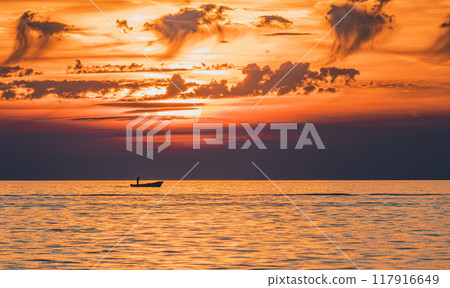 Small fishing boat and fisherman at sunset Small fishing boat and fisherman at sunset 117916649