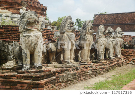 Singha or lion statues around the Main pagoda at Wat Thammickarat deteriorated over time But it also shows the grandeur and indicates the ancient architecture of the Ayutthaya period as well.Thailand. 117917356