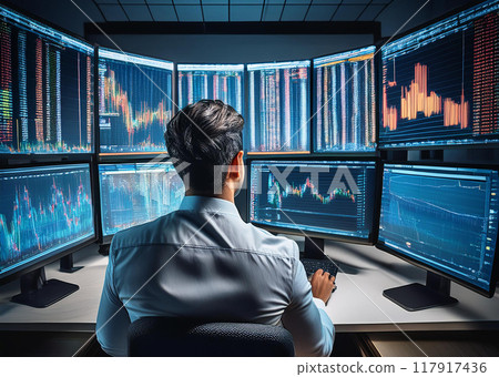Stock trader looking at monitor Stock trader looking at monitor 117917436
