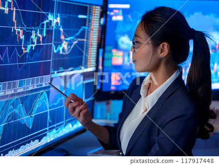 Stock trader looking at monitor Stock trader looking at monitor 117917448