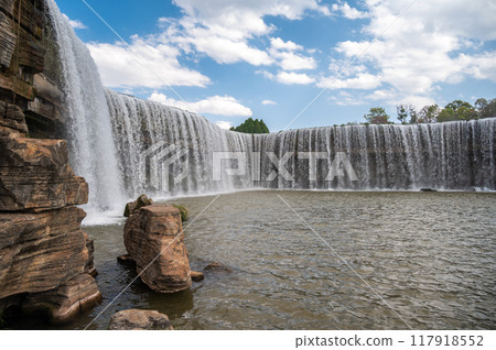 Beautiful view of Kunming waterfall park in China. The waterfall is claimed to be the largest man-made one in Asia which is 12.5 meters in height and 400 meters in width. 117918552