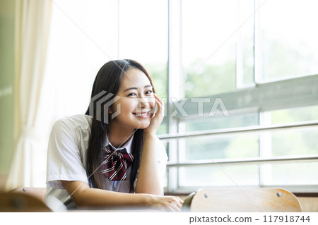 High school girl sitting on a chair in the classroom 117918744