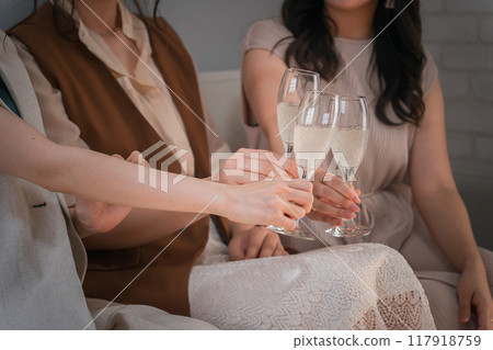 Women, colleagues, female friends, and mom friends toasting with champagne glasses Women, colleagues, female friends, and mom friends toasting with champagne glasses 117918759