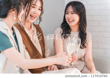 Women, colleagues, female friends, and mom friends toasting with champagne glasses Women, colleagues, female friends, and mom friends toasting with champagne glasses 117918760