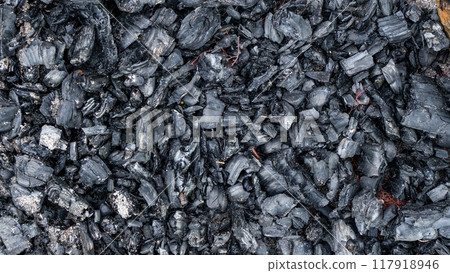 Black charcoal texture from burnt wood. Black charcoal texture from burnt wood. 117918946