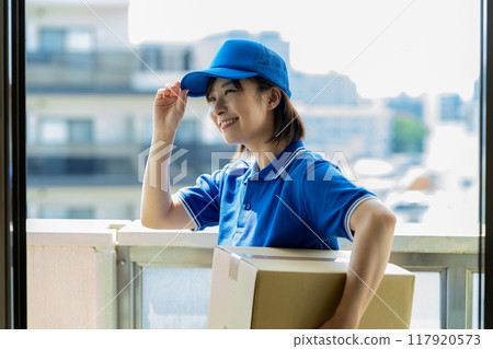 Courier female driver delivering luggage Courier female driver delivering luggage 117920573