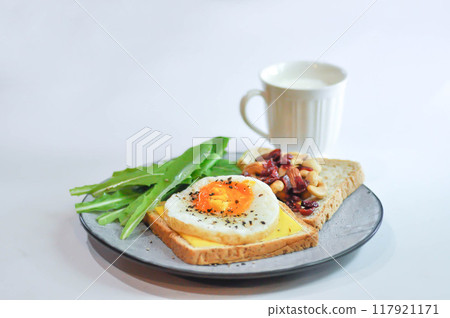 bread with egg and cheese topping or  sunny side up egg , lettuce and almond with dried cranberry and milk 117921171