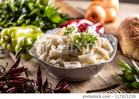 Precooked beef tripes in a bowl with vegetables and herbs ready for cooking 117921230