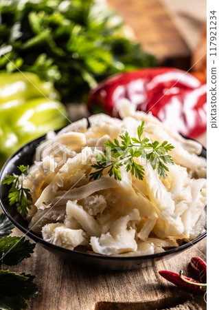 Precooked beef tripes in a bowl with vegetables and herbs ready for cooking Precooked beef tripes in a bowl with vegetables and herbs ready for cooking 117921234