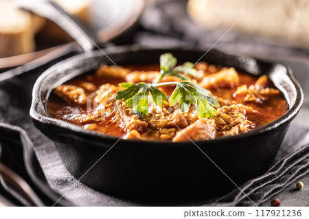Tasty soup or stew made of beef tripe and spices. Spicy and aromatic tripe soup seasoned with pepper and served with bread Tasty soup or stew made of beef tripe and spices. Spicy and aromatic tripe soup seasoned with pepper and served with bread 117921236