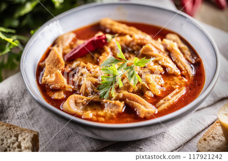 Tasty soup or stew made of beef tripe and spices. Spicy and aromatic tripe soup seasoned with pepper and served with bread Tasty soup or stew made of beef tripe and spices. Spicy and aromatic tripe soup seasoned with pepper and served with bread 117921242