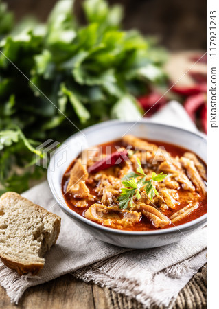 Tasty soup or stew made of beef tripe and spices. Spicy and aromatic tripe soup seasoned with pepper and served with bread Tasty soup or stew made of beef tripe and spices. Spicy and aromatic tripe soup seasoned with pepper and served with bread 117921243