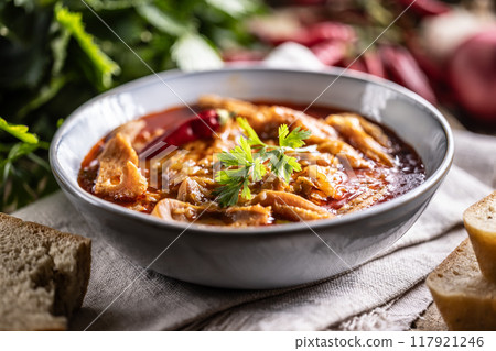 Tasty soup or stew made of beef tripe and spices. Spicy and aromatic tripe soup seasoned with pepper and served with bread Tasty soup or stew made of beef tripe and spices. Spicy and aromatic tripe soup seasoned with pepper and served with bread 117921246