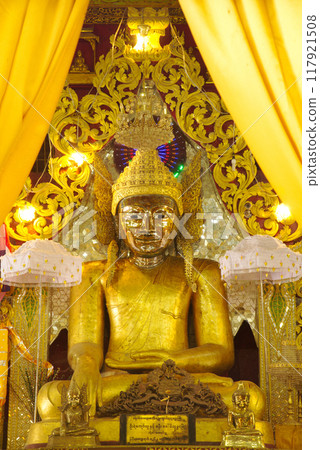 A large golden seated Buddha image is the main Buddha image in the Mahamuni Phrya Temple Church. It is located on the Rakhine State.Myanmar. A large golden seated Buddha image is the main Buddha image in the Mahamuni Phrya Temple Church. It is located on the Rakhine State.Myanmar. 117921508