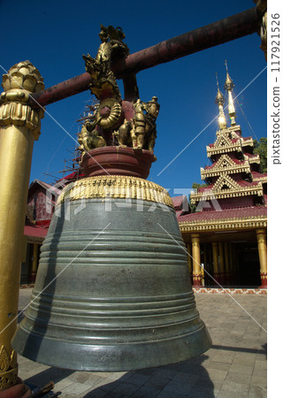 An outdoor large bell hanging front of the chapel or Buddhist church at Wat Mahamuni Phraya temple. It is located on the Rakhine State, Myanmar. 117921526