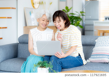 Senior woman learning computer in living room 117921695