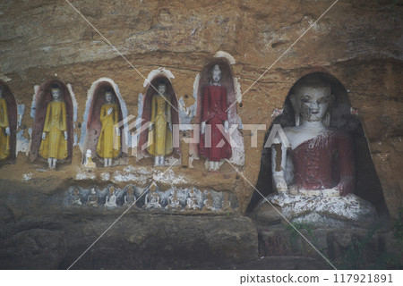 Akauk Taung has a Buddha image carved in sandstone on the Akauk Mountain cliff along the Ayeyavadee River near Htonbo village. Magway Region.Myanmar. 117921891