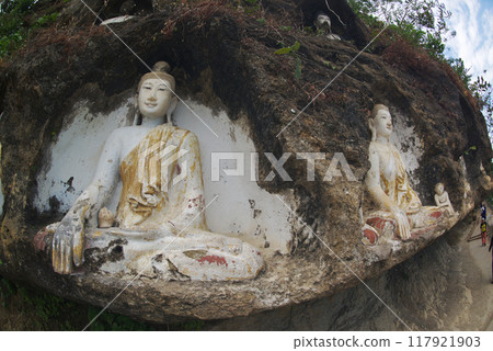 Akauk Taung has Buddha statues carved in sandstone in various forms such as sitting and standing on the cliff of Mount Akauk along the Ayeyavadee River near Htonbo Village, Magway District, Myanmar. 117921903