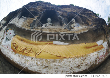 Akauk Taung has Buddha statues carved in sandstone in various forms such as sitting and reclining on the cliff of Mount Akauk along the Ayeyavadee River near Htonbo Village, Magway District, Myanmar. 117921906