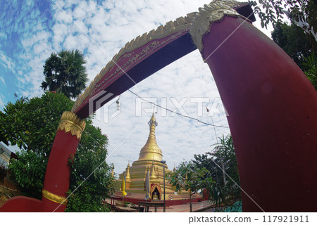 Shwe Myintin Pagoda is located on the top of a Akauk mountain, below which there has a Buddha image carved in sandstone on the cliff along the Ayeyavadee River near Htonbo village, Magway Region. Myan Shwe Myintin Pagoda is located on the top of a Akauk mountain, below which there has a Buddha image carved in sandstone on the cliff along the Ayeyavadee River near Htonbo village, Magway Region. Myan 117921911