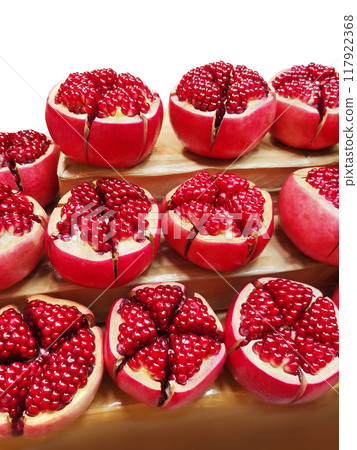 Fresh pomegranate. Picture of a pomegranate cut in half to reveal the seeds inside. Fresh pomegranate. Picture of a pomegranate cut in half to reveal the seeds inside. 117922368