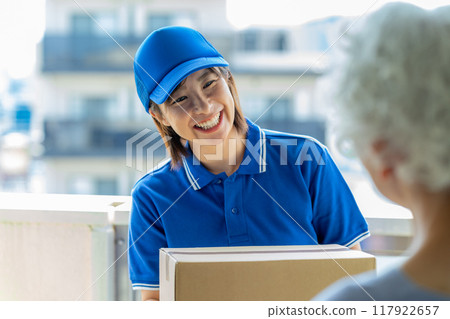Courier female driver delivering luggage 117922657