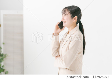 Business woman making a phone call Business woman making a phone call 117923072