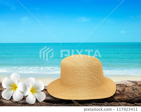 Vintage hat, wooden icon, flowers and tropical sea background. summer paradise cruise travel design tourism, beach, holiday travel destination concept 117923411