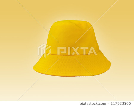 yellow bucket hat isolated on light yellow background 117923500