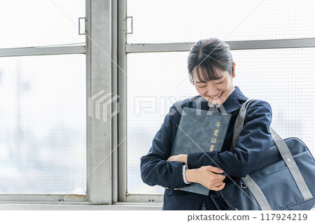 Smiling high school students, junior high school students, high school girls (graduation ceremony, uniform, school uniform) with diplomas and certificate files in school classrooms 117924219