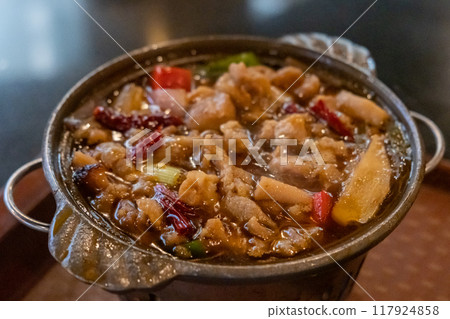 Chicken hot pot, with vegetables in soup. served in the restaurant Chicken hot pot, with vegetables in soup. served in the restaurant 117924858