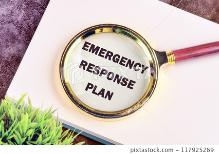 ERP as EMERGENCY RESPONSE PLAN written through a magnifying glass in a business record book 117925269