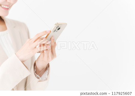 A woman in a suit manipulating a smartphone A woman in a suit manipulating a smartphone 117925607