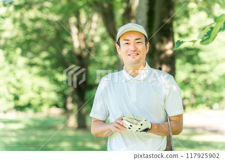 Male golfer using smartphone on golf course (app, score, score management, course strategy, course map) 117925902
