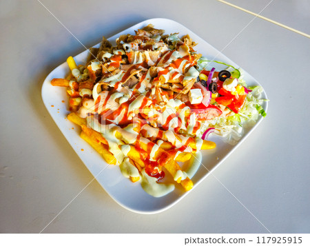 Kebab with french fries on white plate. Kebab with beef meat. Kebab with french fries on white plate. Kebab with beef meat. 117925915