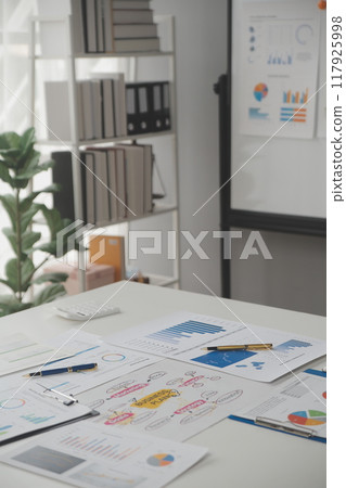 Close up of Business team analyzing income charts and graphs with modern laptop computer. Business analysis and strategy concept. 117925998