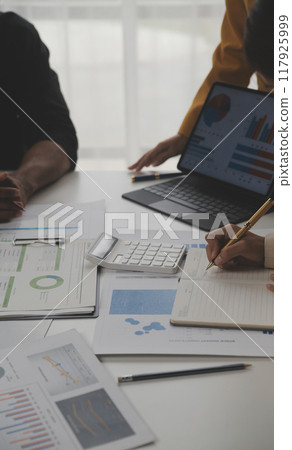 Close up of Business team analyzing income charts and graphs with modern laptop computer. Business analysis and strategy concept. 117925999