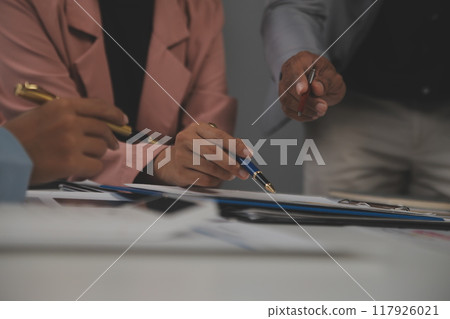Close up of Business team analyzing income charts and graphs with modern laptop computer. Business analysis and strategy concept. 117926021
