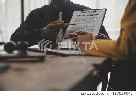 Judge gavel with Justice lawyers having team meeting at law firm background. Concepts of Law and Legal services. 117926042