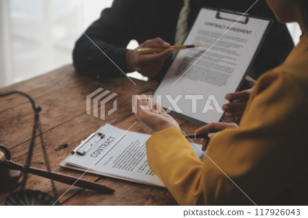 Judge gavel with Justice lawyers having team meeting at law firm background. Concepts of Law and Legal services. 117926043