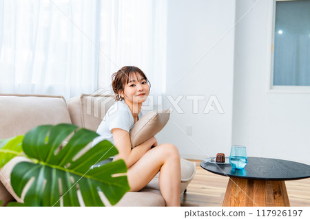 Woman in loungewear relaxing on sofa / Holiday morning / Relaxing 117926197