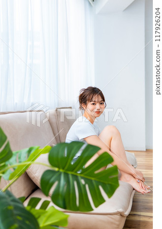 Woman in loungewear relaxing on sofa / Holiday morning / Relaxing 117926204