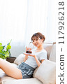 Woman in loungewear relaxing on sofa / Holiday morning / Relaxing 117926218