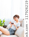 Woman in loungewear relaxing on sofa / Holiday morning / Relaxing 117926219